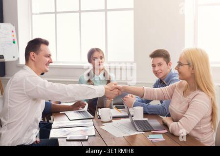 Business handshake at multiethnic office meeting Stock Photo