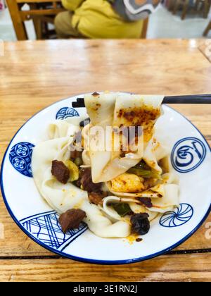 Biangbiang noodles in Xian, Shaanxi, China. Biang biang mian, Chinese Shaanxi cuisine served in Xian Stock Photo