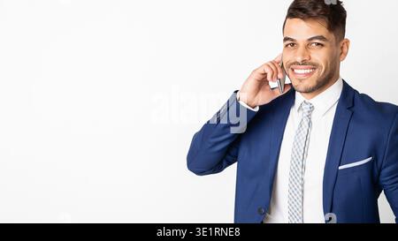 Arab businessman talking on phone and smiling Stock Photo