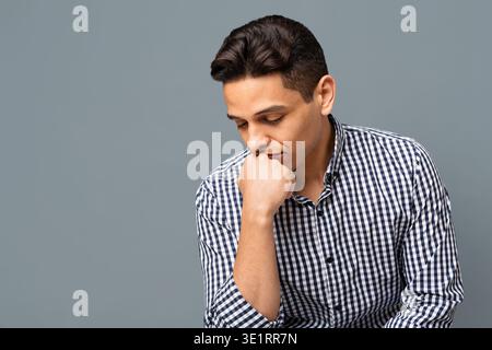 Thoughtful Handsome Man In Checkered Shirt On Gray Background Stock Photo