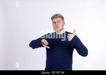 Young man pointing at himself with thumbs Stock Photo