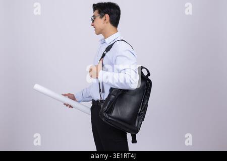 Man looking over shoulder with backpack Stock Photo