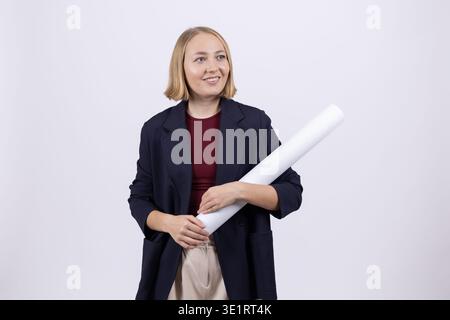 Woman holding rolled blueprints and smiling Stock Photo