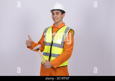 Worker in safety vest showing thumbs up gesture Stock Photo