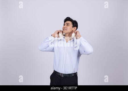 Young man in white shirt looking up in thoughts Stock Photo