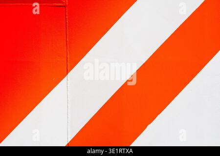 Orange and white diagonal stripes pattern on industrial container Stock Photo