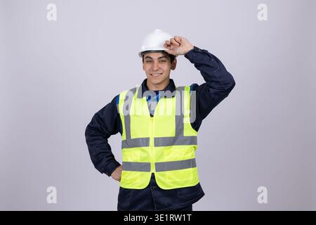 Worker in yellow safety vest adjusting his helmet Stock Photo