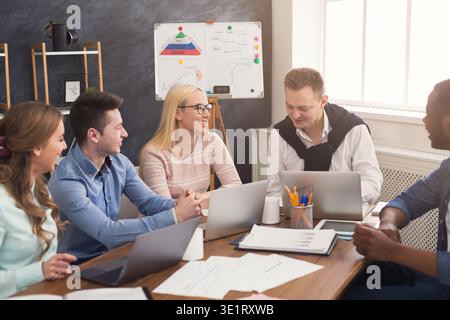 Young team discussing project in modern office Stock Photo