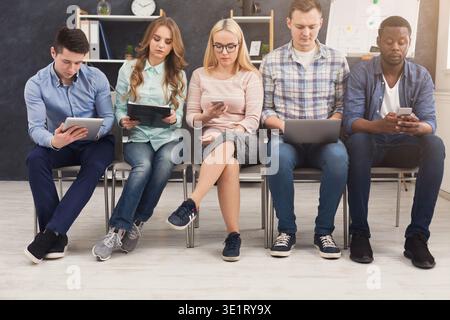 Group of business people sitting on chairs Stock Photo