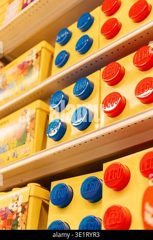 Chemnitz, Germany - March 14, 2026: LEGO boxes of different colors are arranged on shelves in a retail store. The display shows various sizes and desi Stock Photo