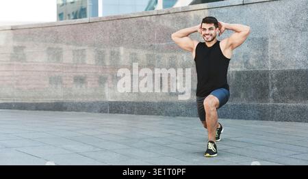 Young millennial sporsman doing morning exercises with happy face Stock Photo