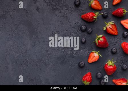 Blueberry and strawberry pattern on black background Stock Photo