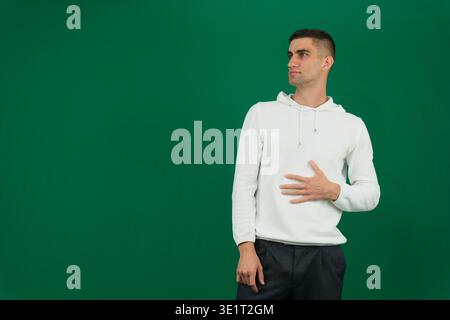 Close-up photo of a young Indian man in an office, holding a napkin and feeling unwell. High quality photo Stock Photo