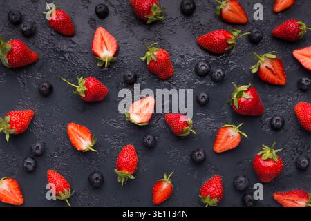 Blueberry and strawberry pattern on black background Stock Photo