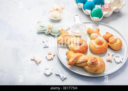 Traditional sweet Easter buns  with colorful eggs for a brunch Stock Photo