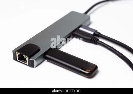 Modern silver USB-C hub with multiple ports for connecting peripheral devices. Perfect for laptops, office, or travel. Shot on white background highli Stock Photo