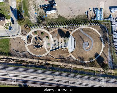 Aerial view of a circular park with a winding path in a residential ...