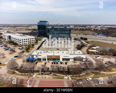 Aerial view of modern buildings and a busy parking lot under a cloudy sky, Frisco, Texas, United States. Stock Photo