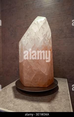 Faceted Himalayan Salt Crystal Lamp on Stone Counter in Spa Setting Stock Photo