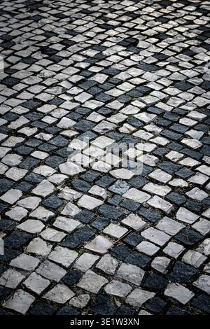Black and white, checkered, patterned, abstract, square, cobblestone street pavement. Stock Photo