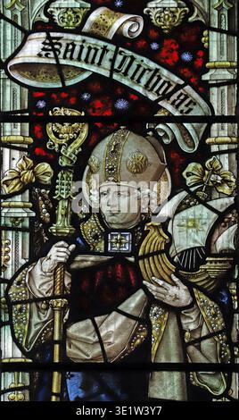 Stained glass window by Percy Bacon & Brothers depicting St Nicholas holding the model of a ship, St Nicholas Church, Brandiston, Norfolk Stock Photo