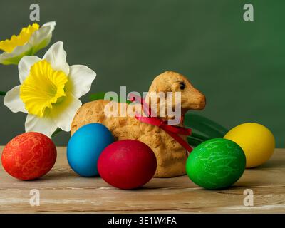 lamb made of bread, eggs painted in different colors, background, wallpaper, Easter composition, festive details Stock Photo