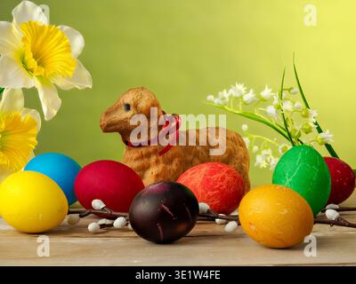 lamb made of bread, eggs painted in different colors, background, wallpaper, Easter composition, festive details Stock Photo