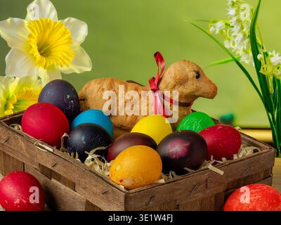 lamb made of bread, eggs painted in different colors, background, wallpaper, Easter composition, festive details Stock Photo