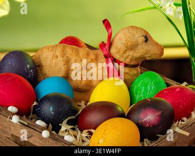 lamb made of bread, eggs painted in different colors, background, wallpaper, Easter composition, festive details Stock Photo