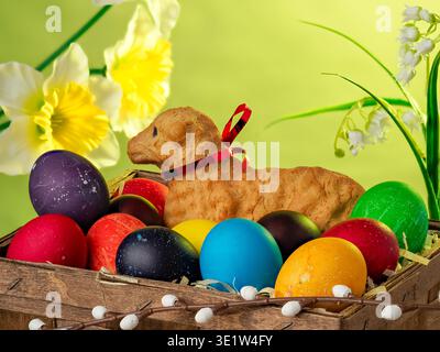 lamb made of bread, eggs painted in different colors, background, wallpaper, Easter composition, festive details Stock Photo
