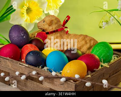 lamb made of bread, eggs painted in different colors, background, wallpaper, Easter composition, festive details Stock Photo