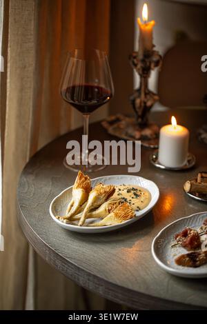 Grilled artichokes and bresaola appetizers with wine Stock Photo