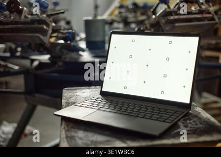 Laptop Computer Displaying Calibration Screen in Industrial Workshop Setting Stock Photo