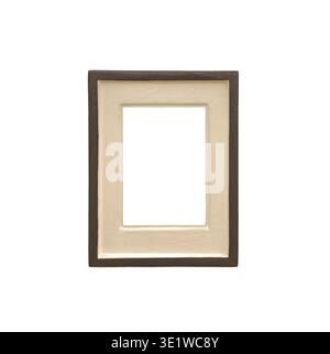 Wooden picture frame with beige mat passepartout stands isolated on white background. Vertical rectangle border surrounds blank copyspace, creating cl Stock Photo