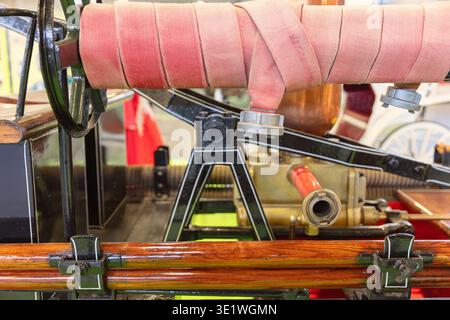 Close-up shows details of an antique fire engine from 1890 including the hose brass fittings and wooden rails Historical vehicle and firefighting conc Stock Photo