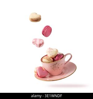 French sweet cookies macarons macaroons in vintage pink cup flying isolated on white background.  Heart shape macarons falling into cup. Pastry shop l Stock Photo
