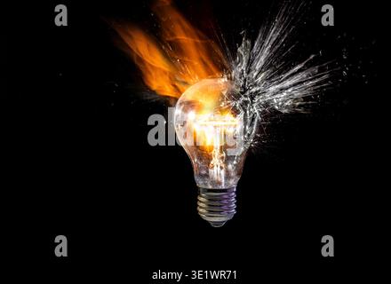 Real Light bulb exploding in a burst of fire Stock Photo