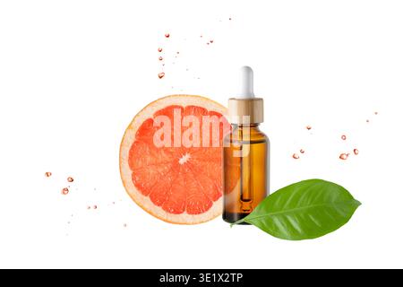 Amber bottle of face serum with vitamin C or essential oil and grapefruit fruit slices and leaves with flying drops isolated on white background. Brow Stock Photo