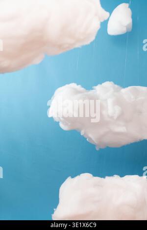 Soft clouds float gently against a calm blue sky. Each cloud drifts with quiet grace and natural texture. Dewdrops cling to edges, hinting at morning' Stock Photo
