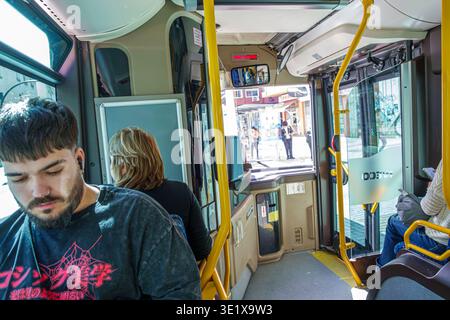 Malaga Spain,Andalusia Andalucia,city public bus transportation,onboard inside interior,passengers riders,elderly man senior citizen using smartphone Stock Photo
