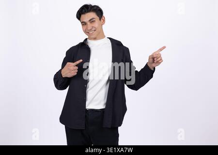 Confident young man pointing at himself with thumbs and smiling Stock Photo