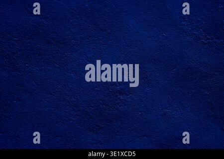 Rich deep blue textured surface ideal for use as a design element or backdrop. Emphasizes bold tones, offers aesthetic appeal for presentations, or st Stock Photo
