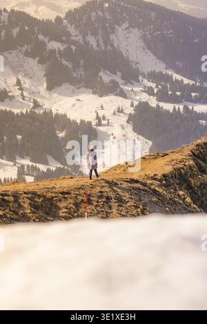 Person standing on snowy mountain enjoying the view of the surrounding winter landscape, Hochgrat Mountains, Allgaeu Alps, Oberreute, Germany Stock Photo