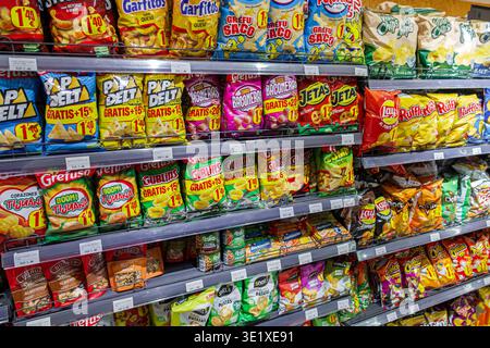 Grocery store chips & snacks aisle. Various brands, flavors, and sizes ...