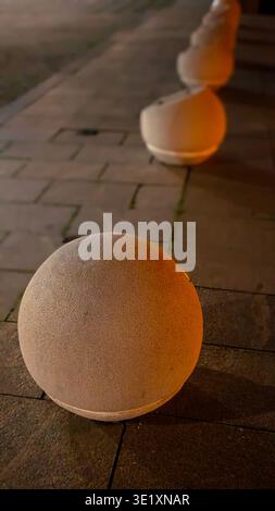 A professional shot of a modern smartphone resting on a slatted wooden bench. The screen is illuminated with colorful application icons, creating a br Stock Photo