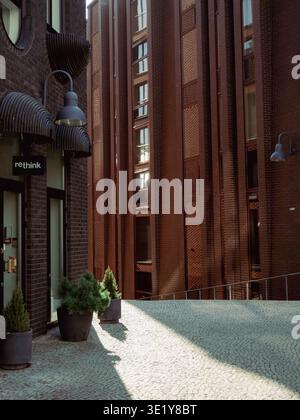 Red brick buildings and cobblestone courtyard with Rethink sign in Rottermani district, Tallinn, spring Stock Photo