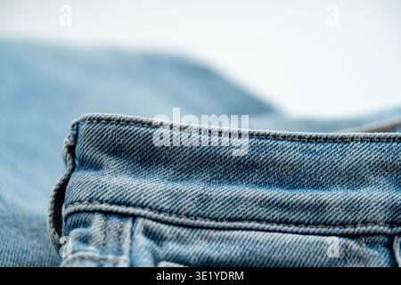 Close up of denim waistband edge with stitching and fabric texture. Stock Photo