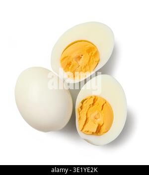 Hard boiled eggs cut in half with bright yellow yolk isolated on white background. Simple healthy food ingredient concept rich in protein, top view Stock Photo