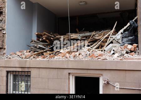 Construction site shows debris and rubble from a building renovation in an urban area in the afternoon Stock Photo