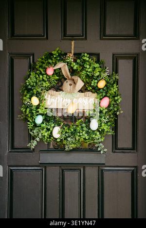 Wreath on a front door showing a bunny and Easter eggs during the spring season Stock Photo